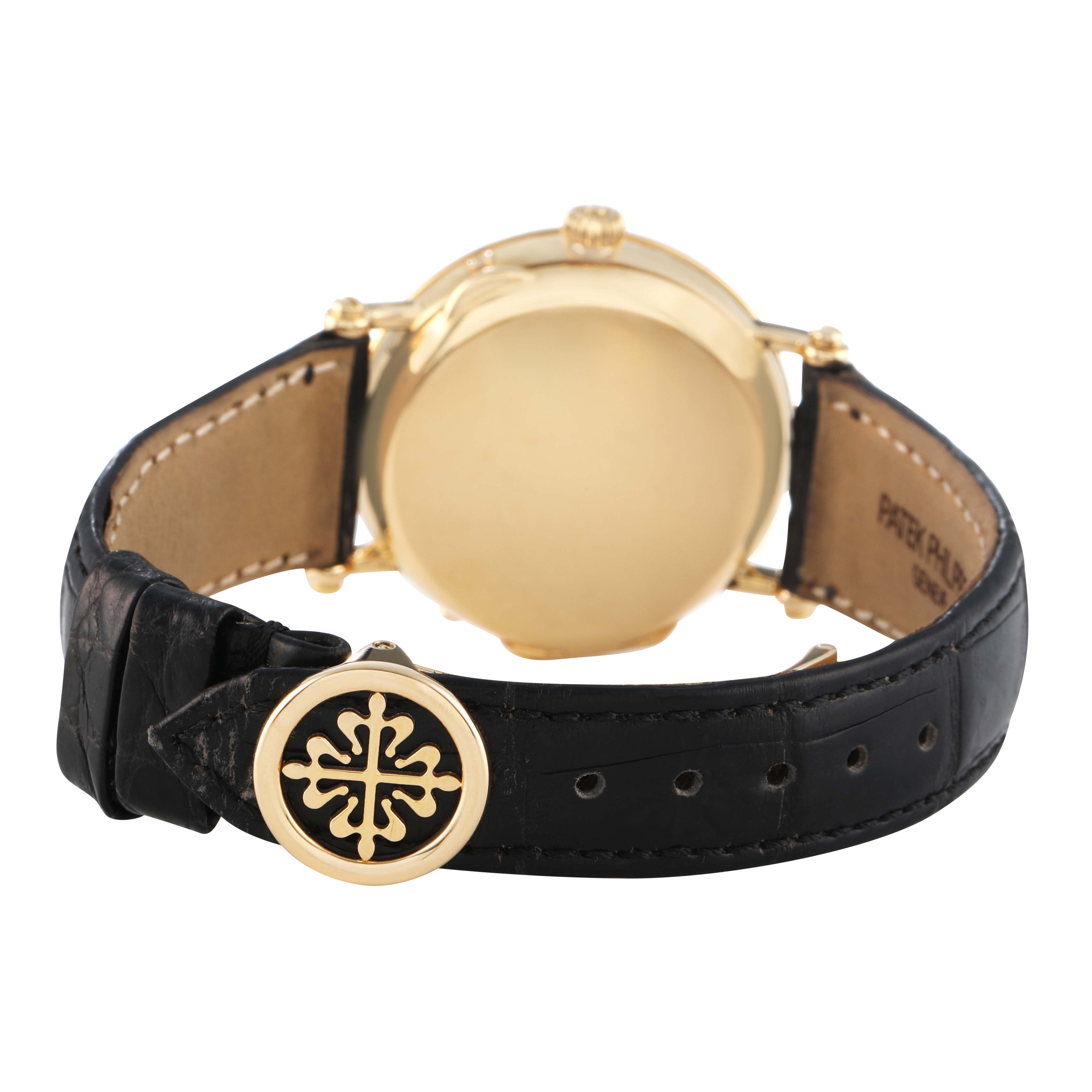 The image shows the back and strap of a Patek Philippe Complications 5054 Men's Yellow Gold White Dial watch, highlighting the clasp and case back.