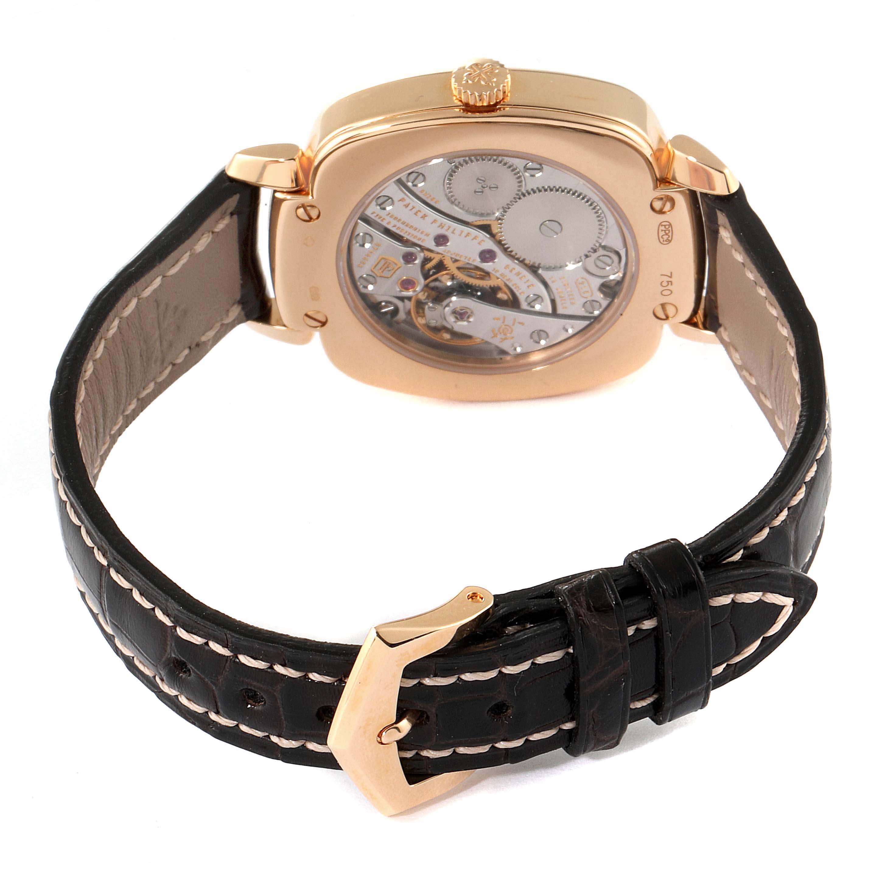 The image shows the rear view of a Patek Philippe Gondolo 7041R-001 Women's Rose Gold Silver Dial 7041R-001 Women's Rose Gold Silver Dial watch displaying its movement and black leather strap.