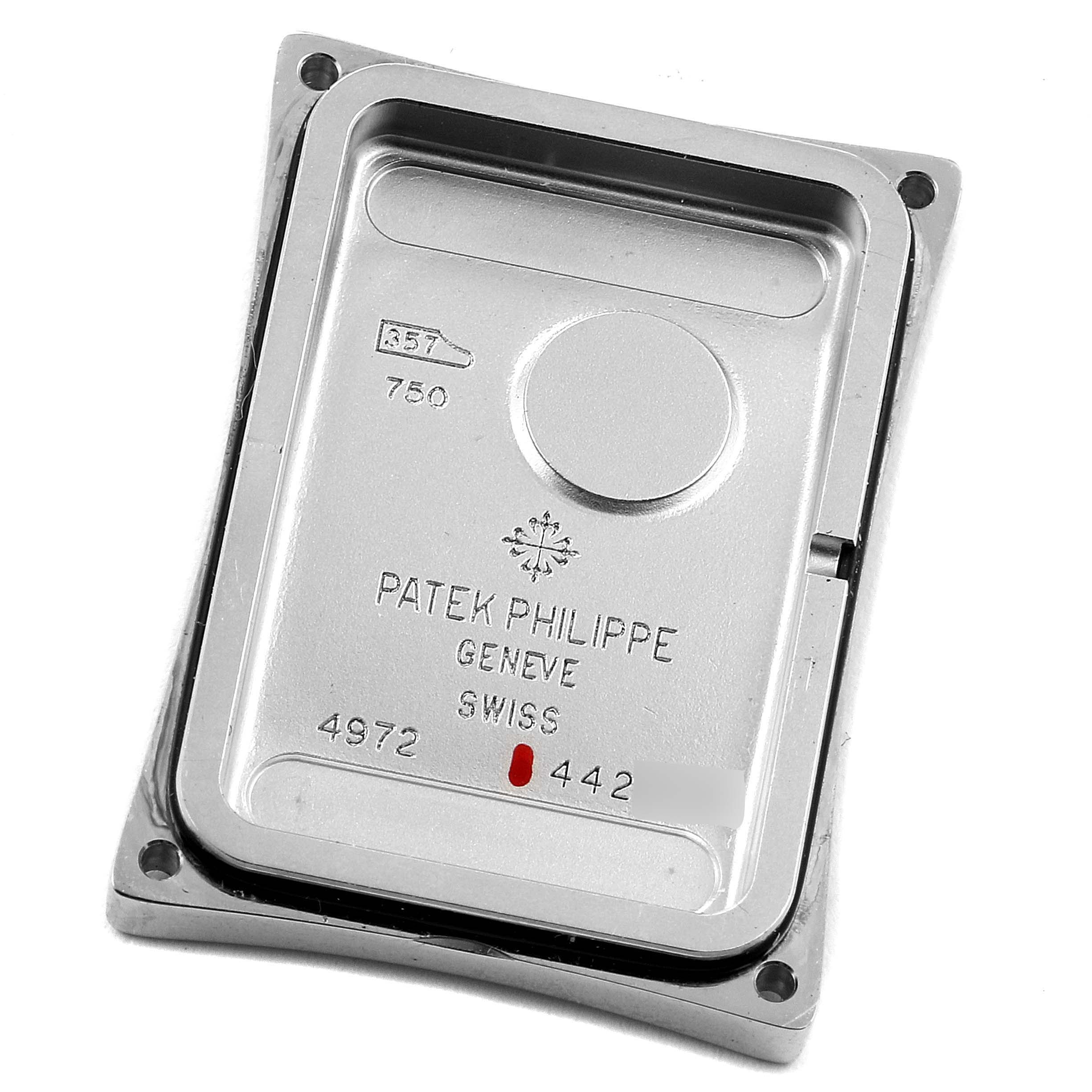 This image shows the back case of a Patek Philippe Gondolo 4972G-001 Women's White Gold Mother of Pearl Dial 4972G-001 Women's White Gold Mother of Pearl Dial watch, displaying branding and serial details.