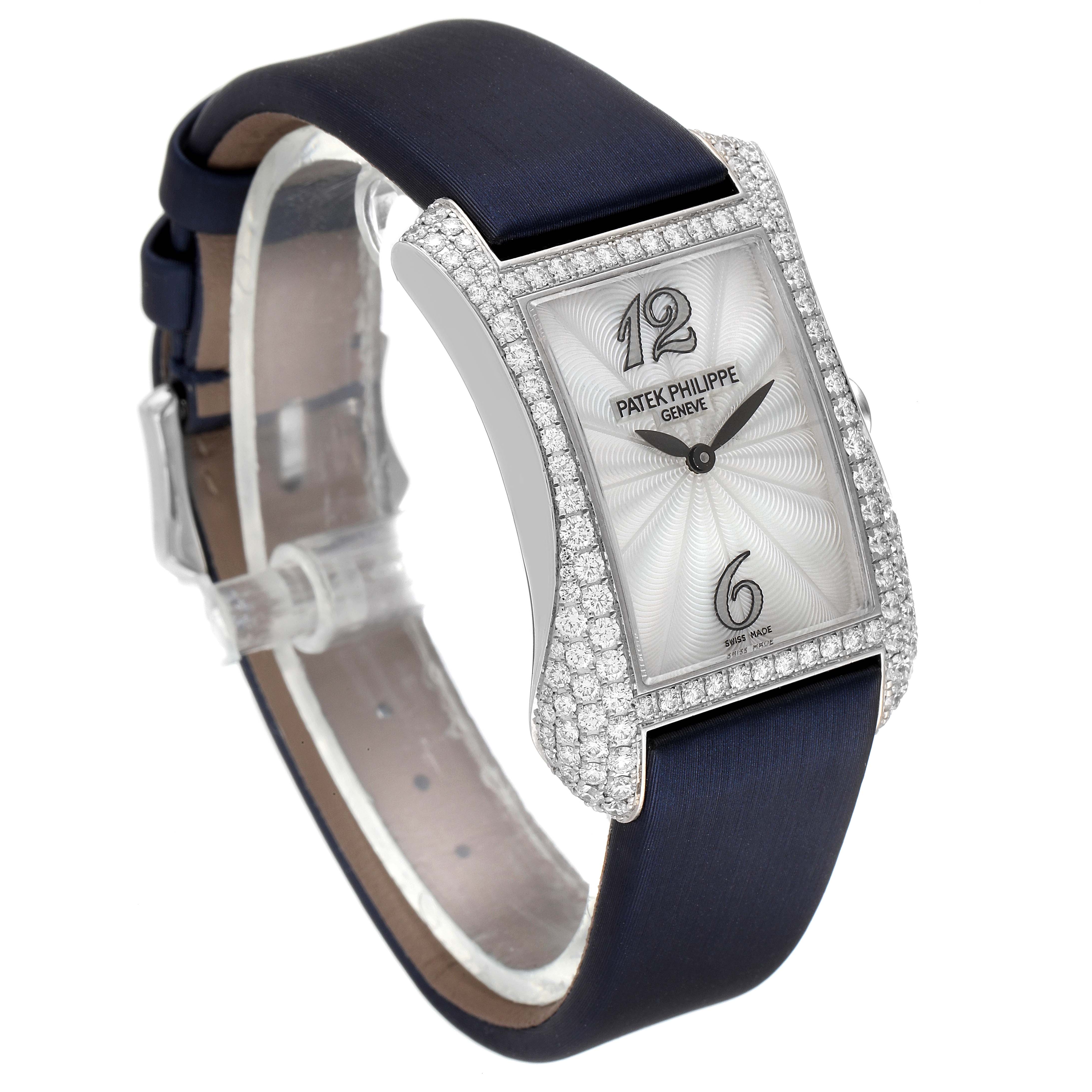 The image shows a side angle of the Patek Philippe Gondolo 4972G-001 Women's White Gold Mother of Pearl Dial 4972G-001 Women's White Gold Mother of Pearl Dial watch, highlighting its diamond-encrusted case and navy strap.