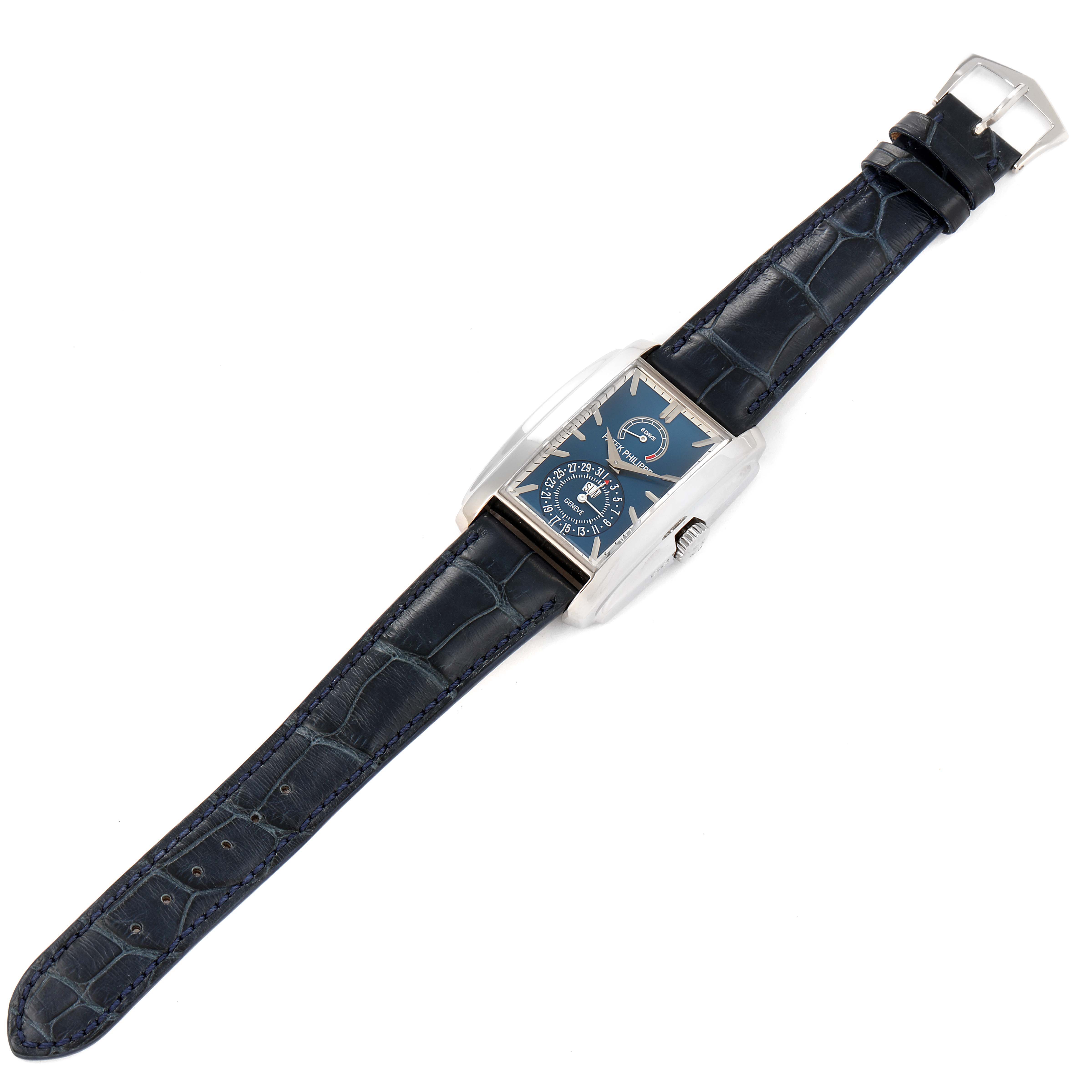 The image shows a Patek Philippe Gondolo 5200G-010 Men's White Gold Blue Dial 5200G-010 Men's White Gold Blue Dial watch from a top-down angle, displaying the dial, case, strap, and buckle.