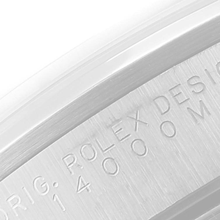 This image shows a close-up of the engraved side bezel of the Rolex Air-King 14000 Men's Stainless Steel Blue Dial 14000 Men's Stainless Steel Blue Dial watch, specifically highlighting the "ROLEX DESIGN" inscription.