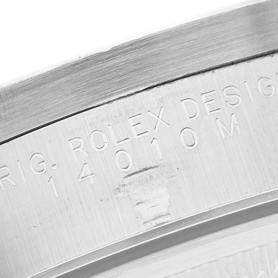 This image shows a close-up of the engraved serial number on the caseback of a Rolex Air-King 14010M Men's Stainless Steel White Dial 14010M Men's Stainless Steel White Dial watch, model number 14010M.