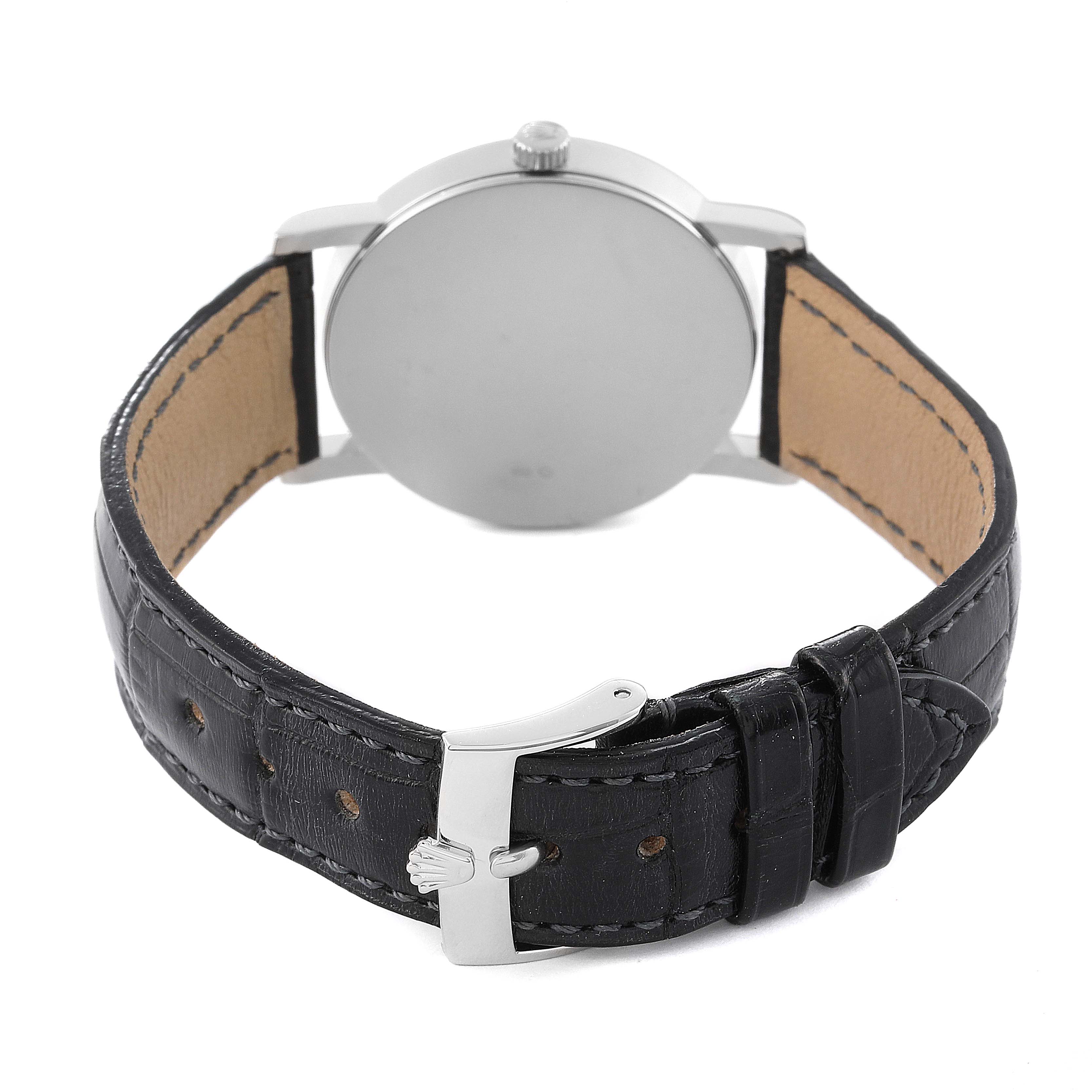 The image shows the back view of the Rolex Cellini 5115 Men
s Stainless Steel Silver Dial 5115 Men
s Stainless Steel Silver Dial watch, focusing on its round case and leather strap with a buckle.