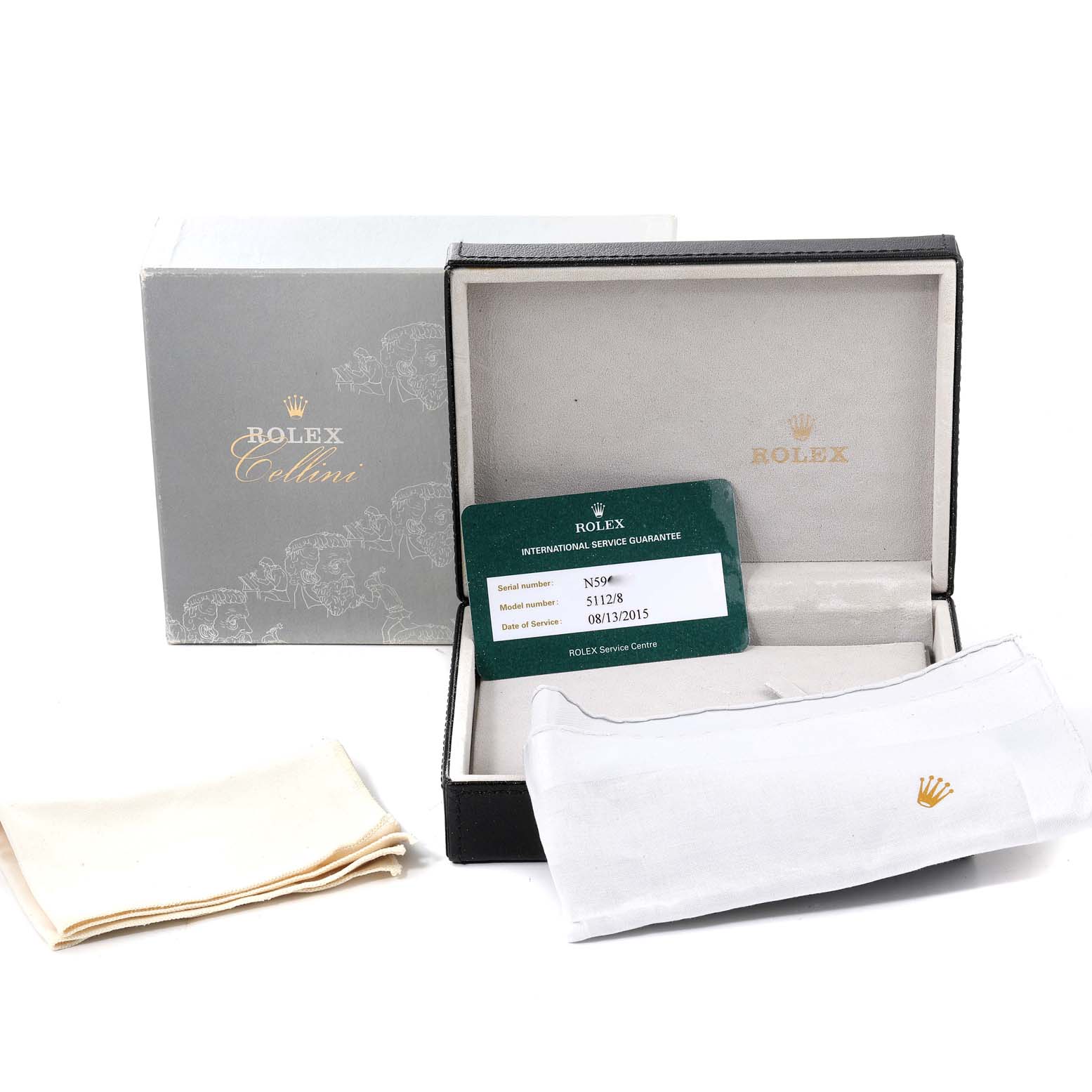 The image shows the accessories of the Rolex Cellini 5112 Men's Yellow Gold Beige Dial 5112 Men's Yellow Gold Beige Dial watch, including its box, service card, and cleaning cloths.