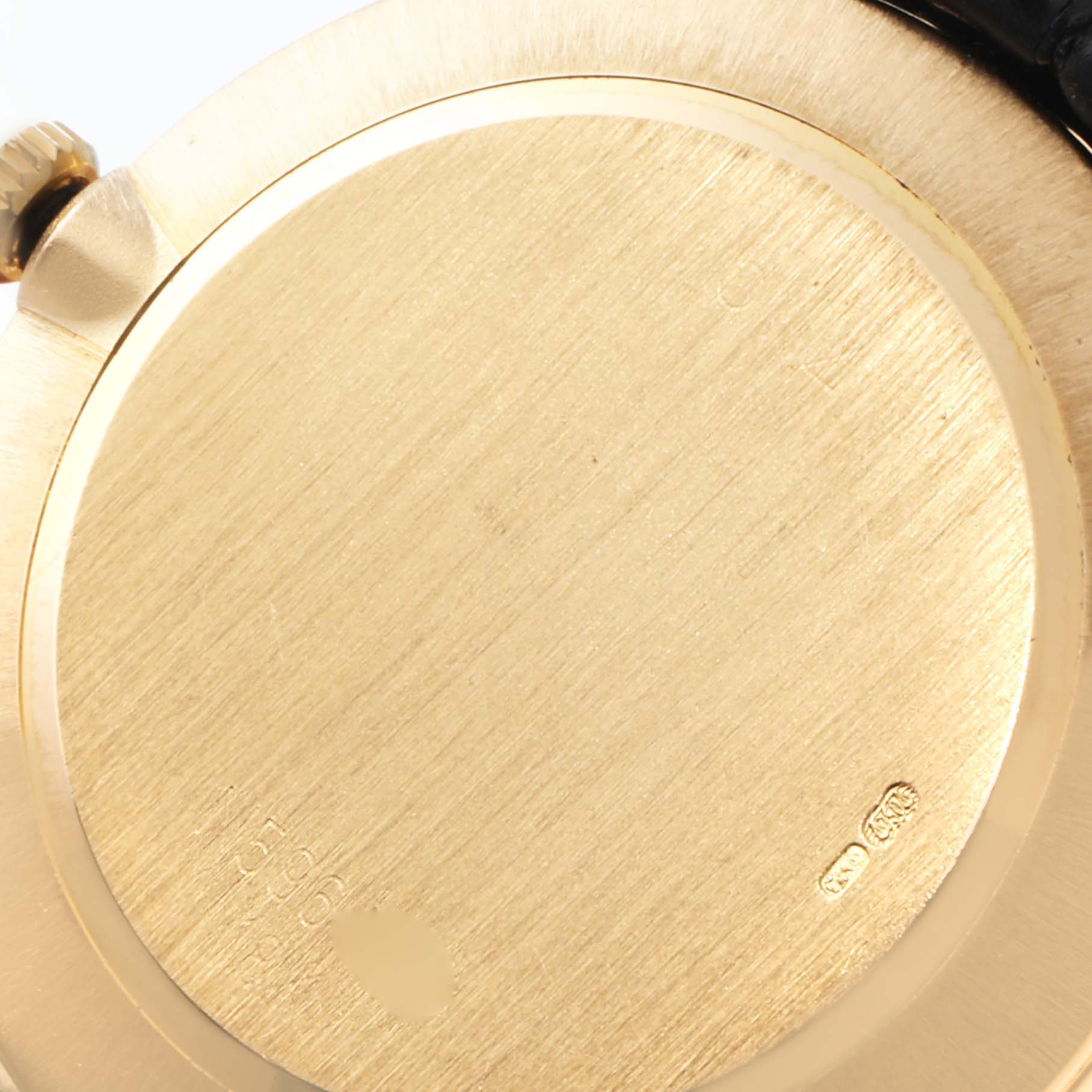 This image shows a close-up view of the back case of a Rolex Cellini 5112 Men's Yellow Gold Beige Dial 5112 Men's Yellow Gold Beige Dial watch, revealing the crown and gold markings.