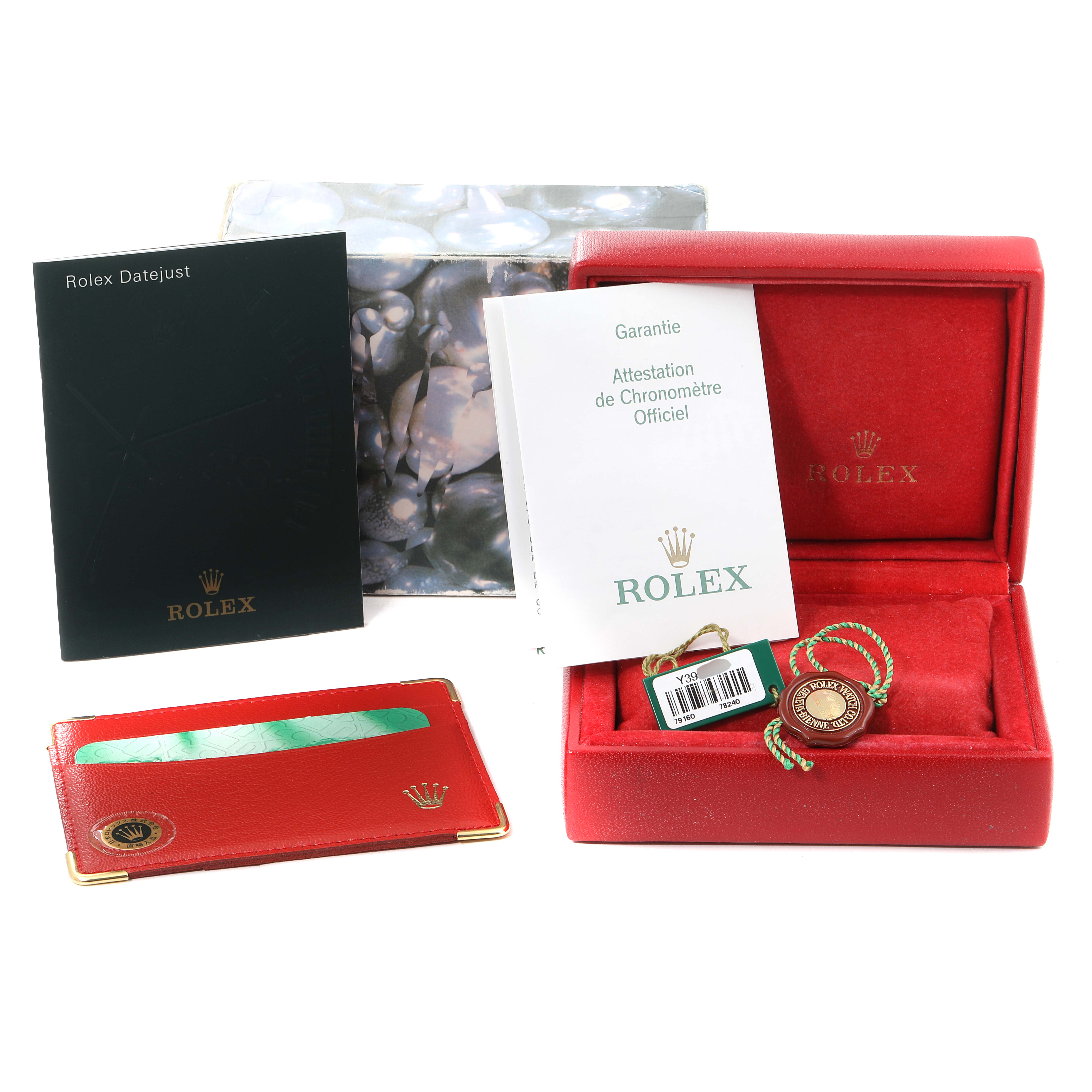 This image shows the packaging, warranty booklets, tag, cardholder, and presentation box for a Rolex Date 79160 Women
s Stainless Steel Black Dial 79160 Women
s Stainless Steel Black Dial model.