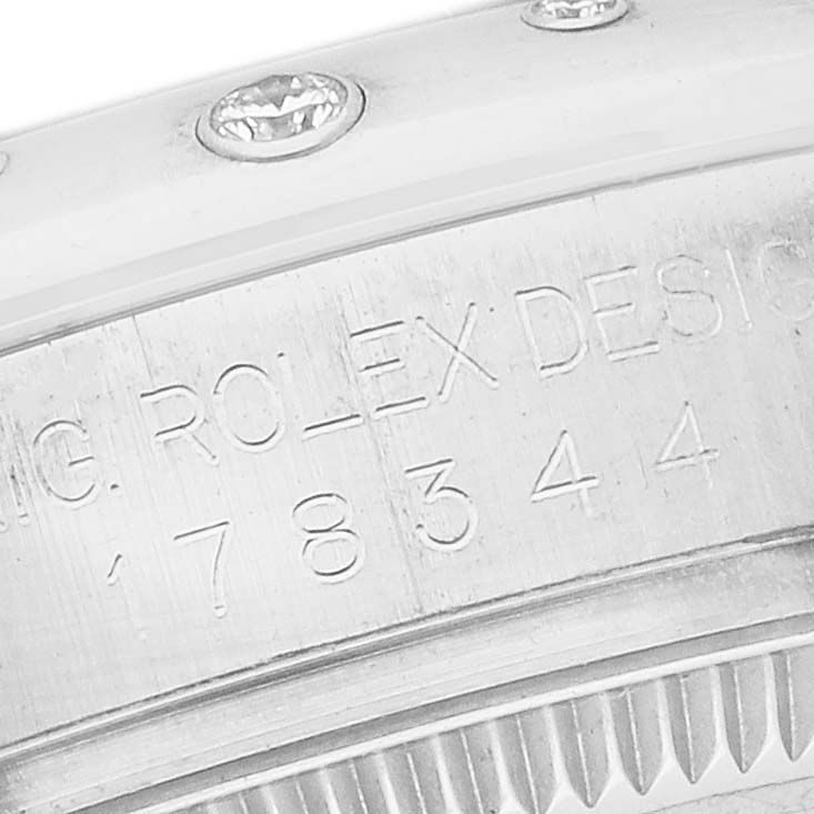 The image shows a close-up of the side of a Rolex Mid-Size 178344 Women's Stainless Steel Mother of Pearl Dial 178344 Women's Stainless Steel Mother of Pearl Dial watch case, highlighting engraved text and partially visible bezel.