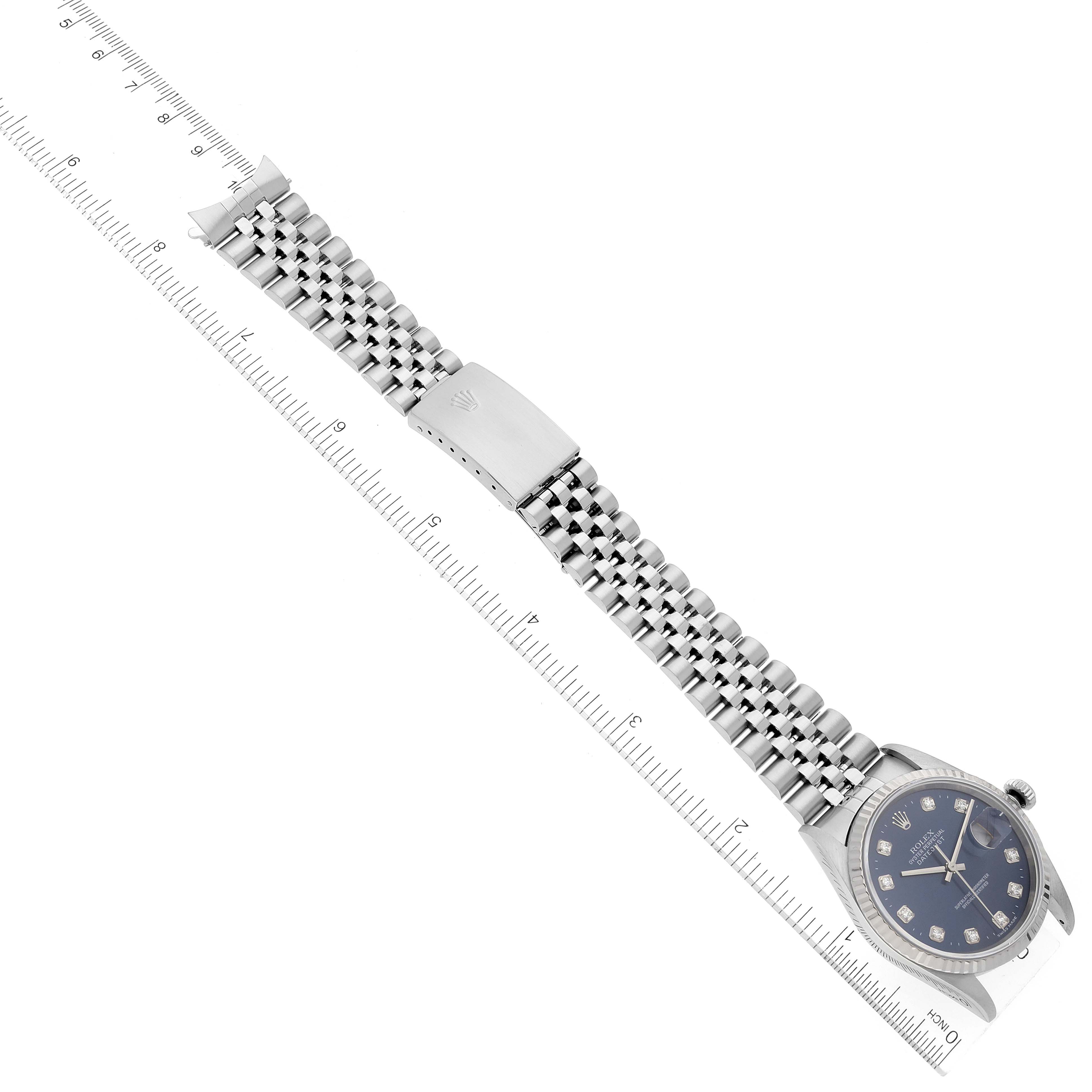 The image shows a Rolex Datejust 16234 Men's Stainless Steel Blue Dial 16234 Men's Stainless Steel Blue Dial watch laid flat with its Jubilee bracelet and clasp visible, alongside a ruler for scale.