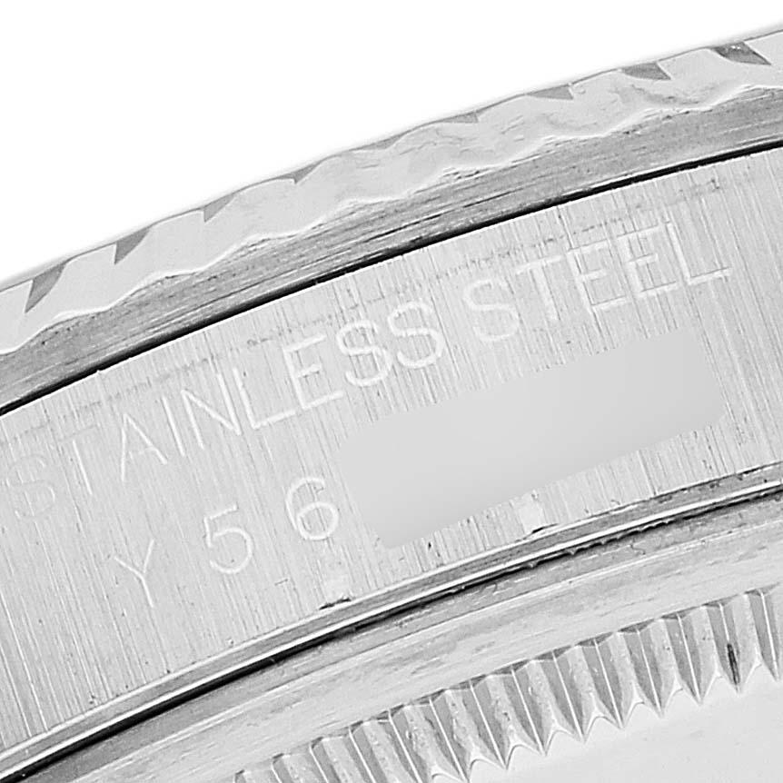 This close-up image shows the engraved stainless steel casing and the fluted bezel of a Rolex Datejust 16234 Men's Stainless Steel Blue Dial 16234 Men's Stainless Steel Blue Dial watch.