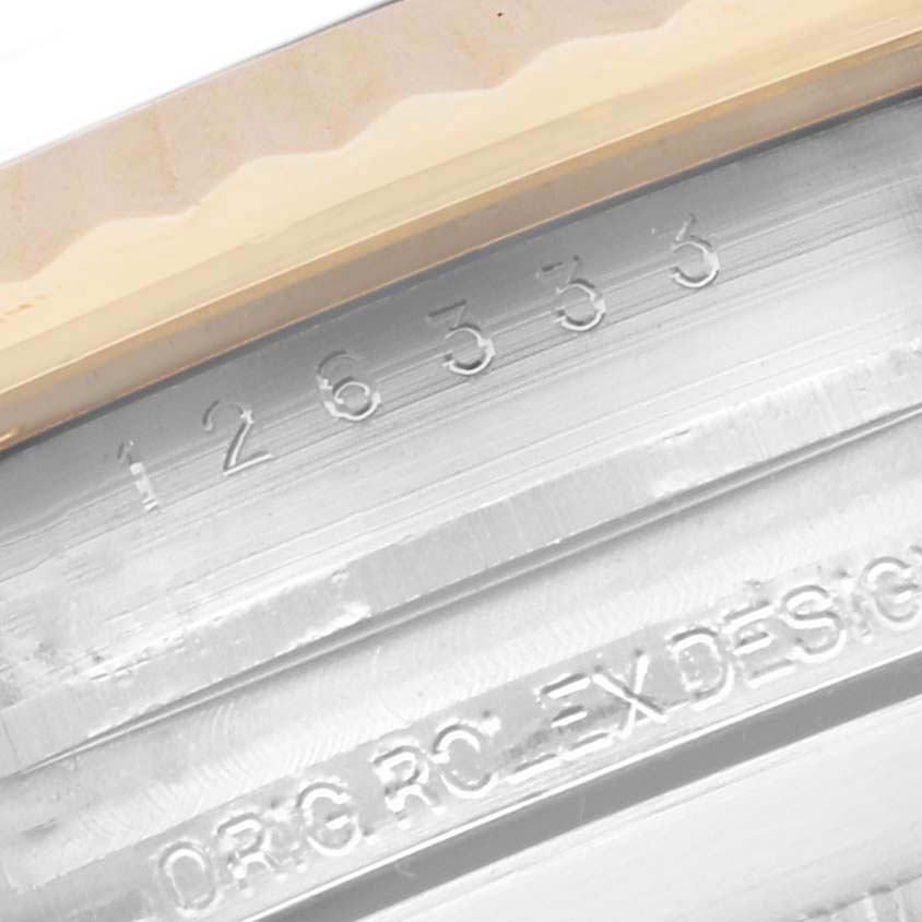 The image shows a close-up of the Rolex Datejust 41 126333 Men's Steel and Gold (two tone) Black Dial 126333 Men's Steel and Gold (two tone) Black Dial model's inner bezel with engraved serial numbers.