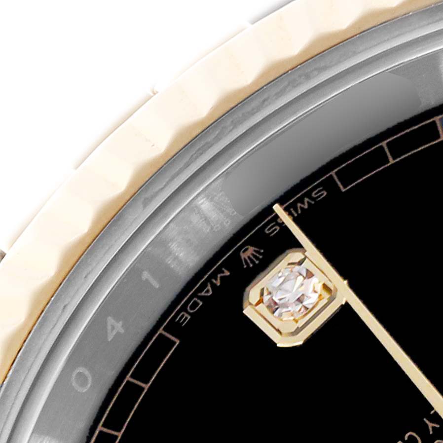The image shows a close-up of the Rolex Datejust 41 126333 Men's Steel and Gold (two tone) Black Dial 126333 Men's Steel and Gold (two tone) Black Dial watch, highlighting the bezel, part of the dial, and a diamond hour marker.