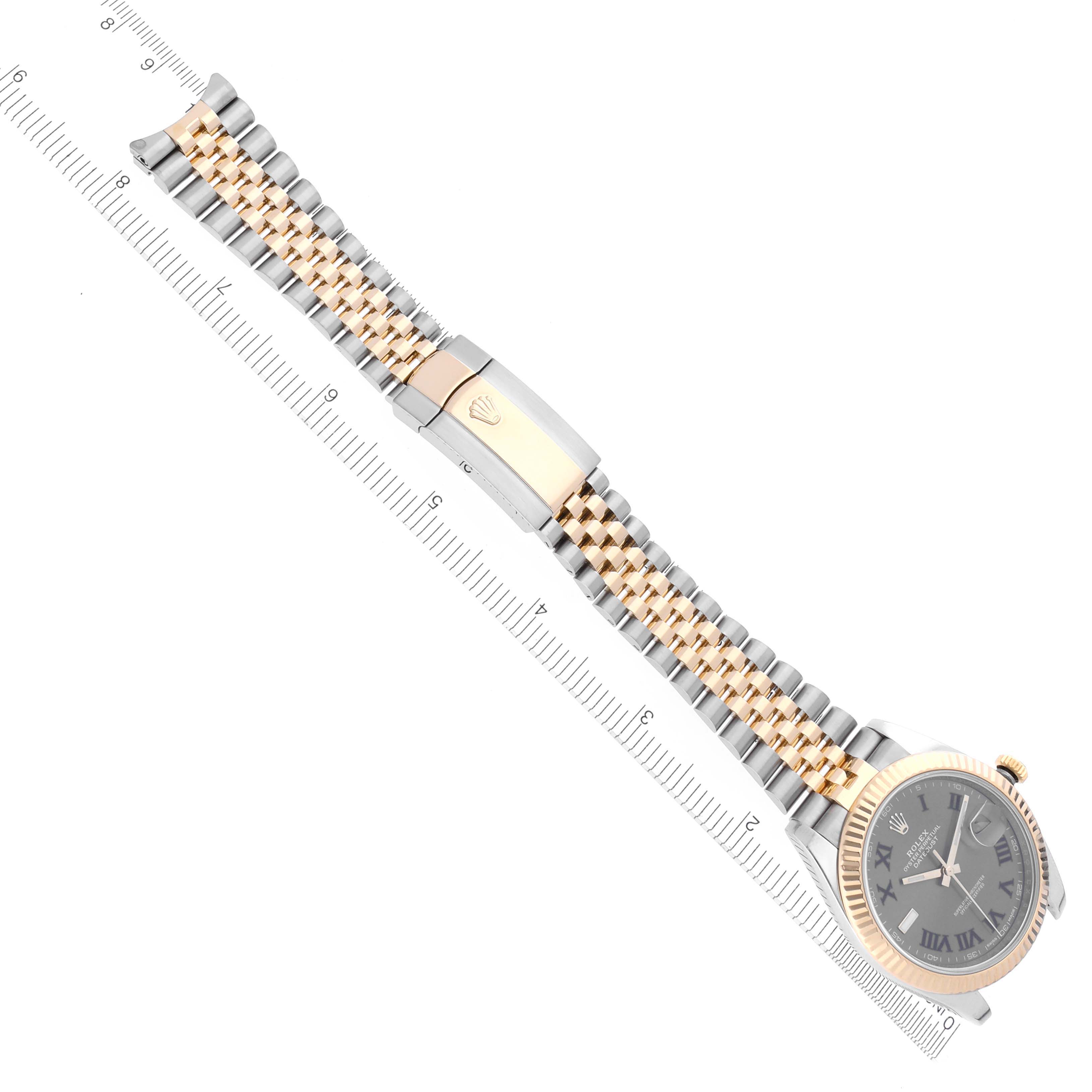 The Rolex Datejust 41 126333 Men's Steel and Gold (two tone) Grey Dial 126333 Men's Steel and Gold (two tone) Grey Dial watch is shown from a top view, displaying its jubilee bracelet, clasp, and face alongside a ruler.