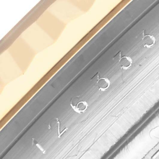 The image shows a close-up of the Rolex Datejust 41 126333 Men's Steel and Gold (two tone) Grey Dial 126333 Men's Steel and Gold (two tone) Grey Dial bezel and part of the engraved serial number.