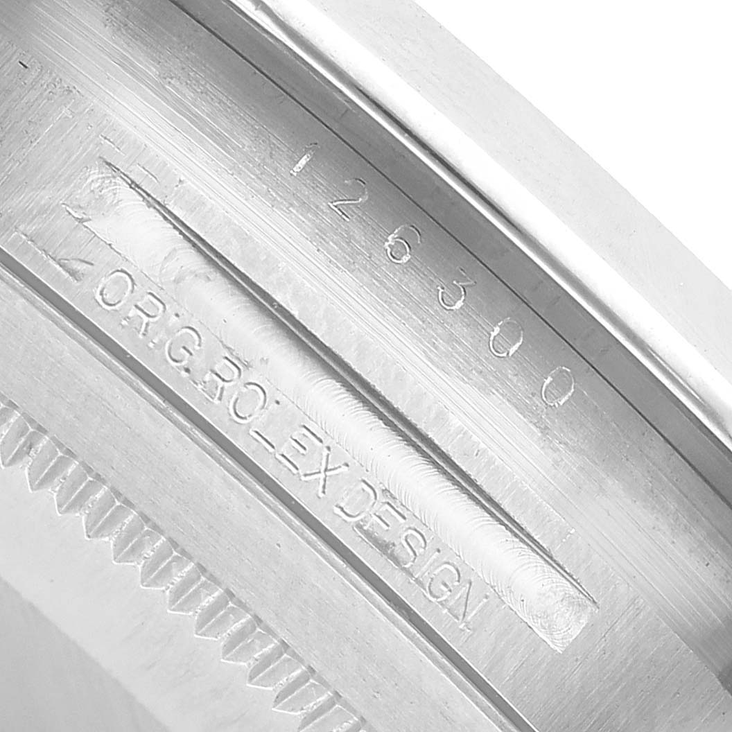 The image shows the engraved inner bezel of a Rolex Datejust 41 126300 Men's Stainless Steel White Dial, highlighting its serial and model numbers.