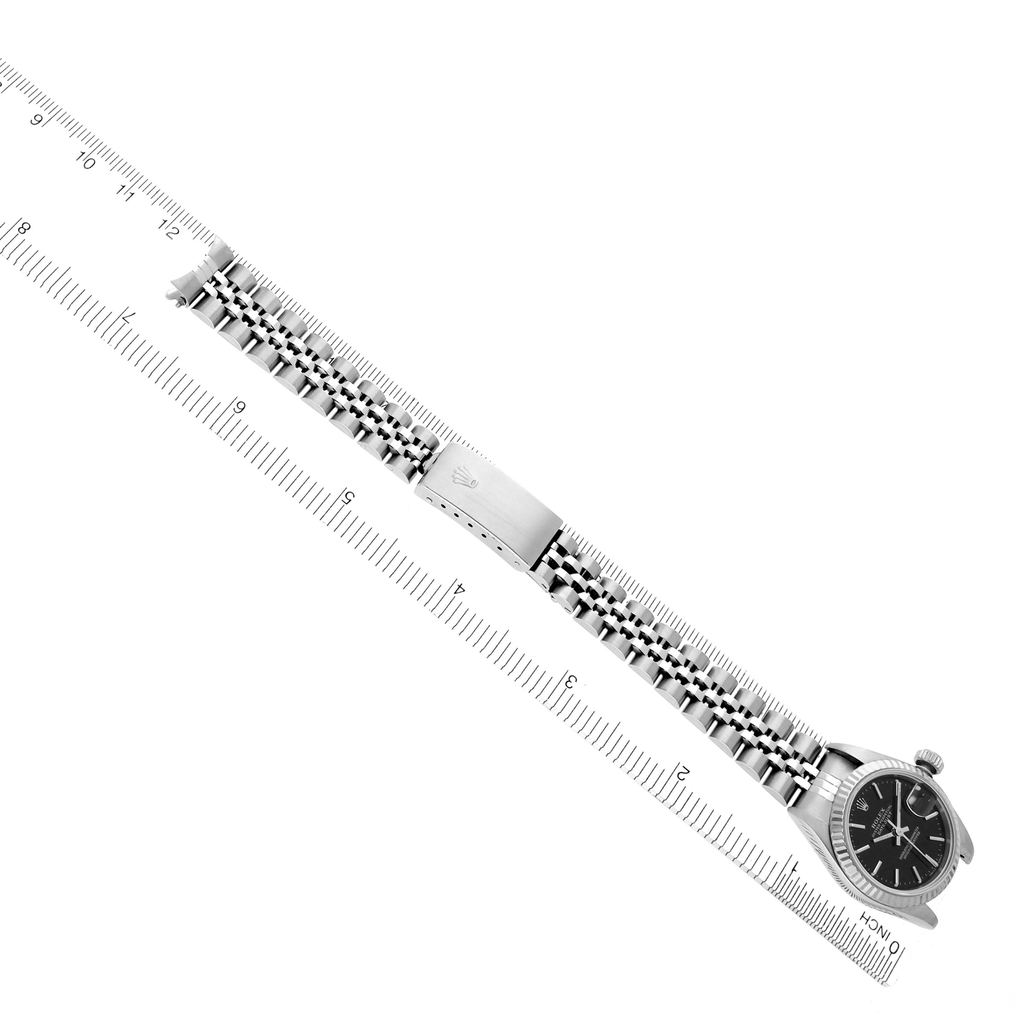 The Rolex Datejust 79174 Women's Stainless Steel Black Dial 79174 Women's Stainless Steel Black Dial watch is shown at a slight angle, highlighting the bracelet, clasp, and watch face.