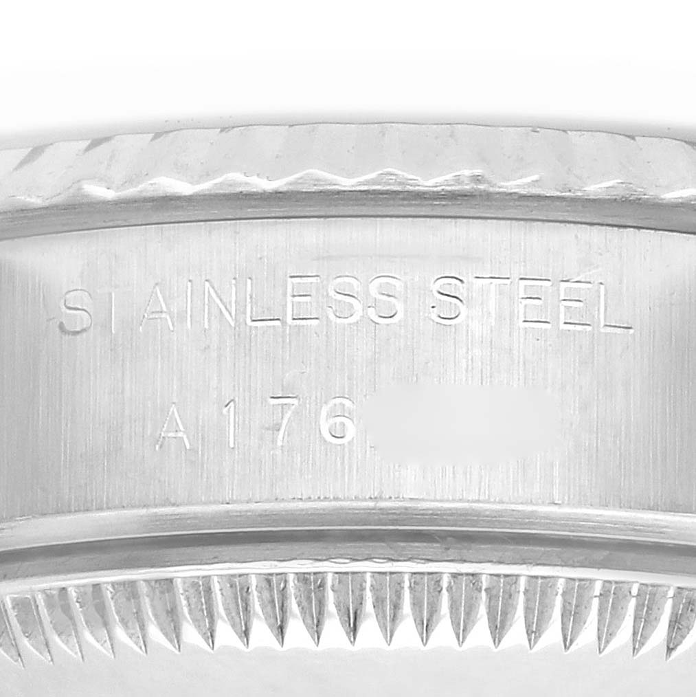 The image shows the side view of a Rolex Datejust 79174 Women's Stainless Steel Black Dial 79174 Women's Stainless Steel Black Dial, focusing on the case's engraved details and the fluted bezel.