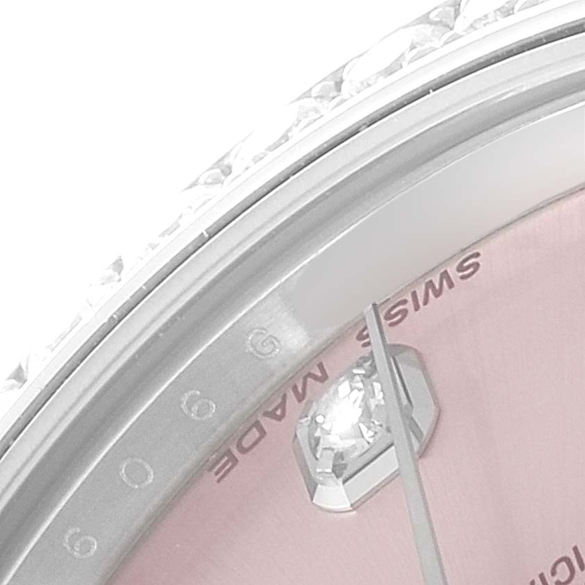 This close-up shows the bezel, diamond hour marker, and dial edge of the Rolex Mid-Size 178384 Women
s Stainless Steel Pink Dial 178384 Women
s Stainless Steel Pink Dial watch.