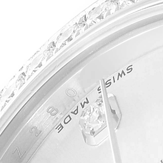 This close-up image of the Rolex Mid-Size 178384 Women
s Stainless Steel Silver Dial 178384 Women
s Stainless Steel Silver Dial watch shows a section of the bezel and a partial view of the dial with the "SWISS MADE" inscription.