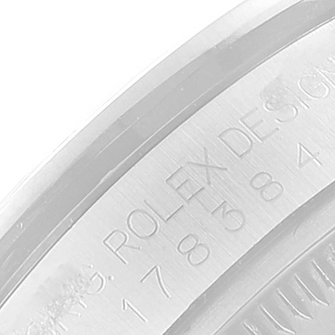This image shows a close-up of the engraved bezel of a Rolex Mid-Size 178384 Women
s Stainless Steel Silver Dial 178384 Women
s Stainless Steel Silver Dial watch.