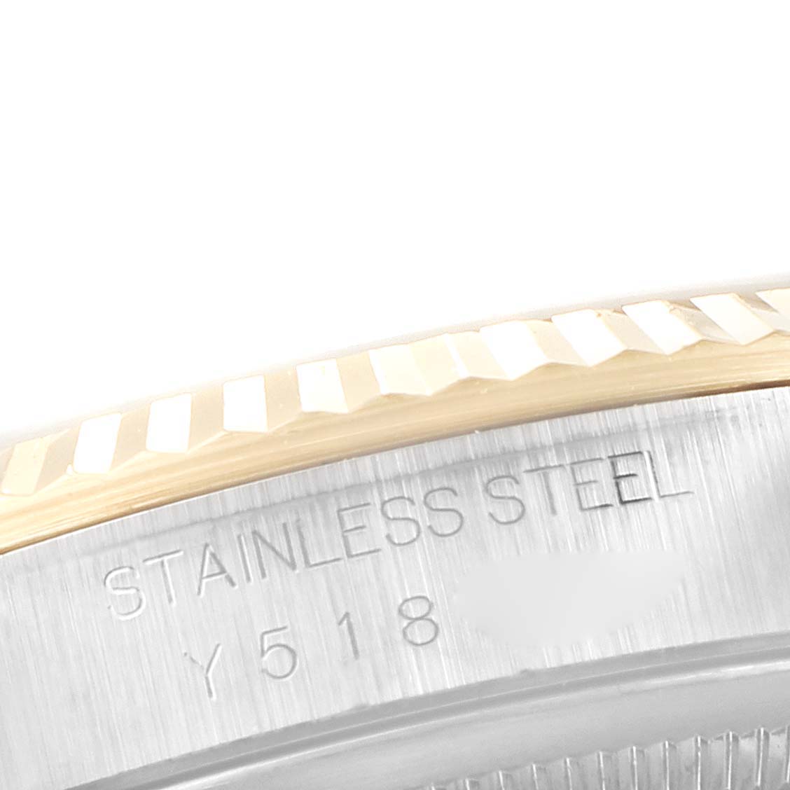 The image shows a close-up of the fluted bezel and the side of the stainless steel case of a Rolex Datejust 16233 Men's Steel and Gold (two tone) White Dial 16233 Men's Steel and Gold (two tone) White Dial watch.