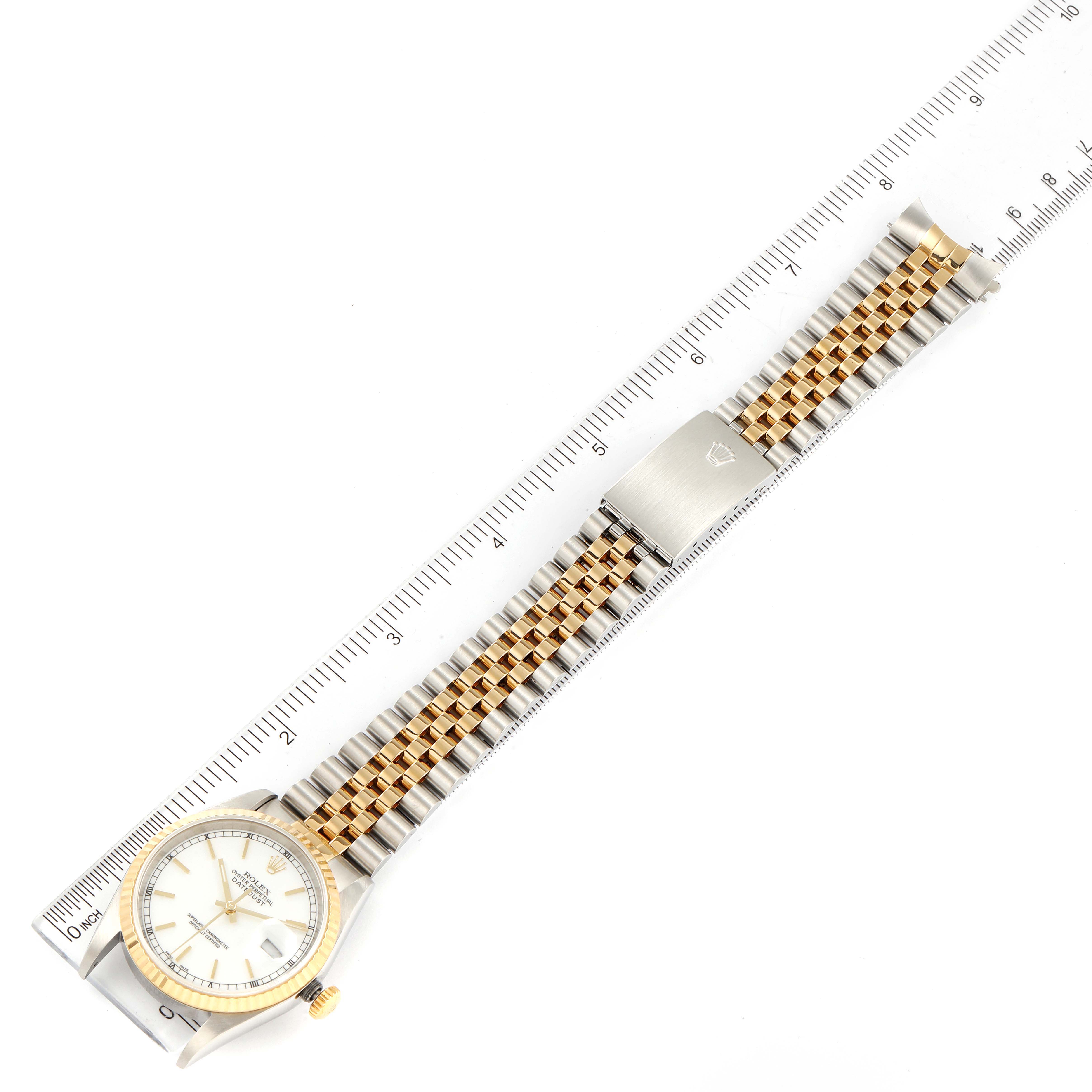 The image shows a Rolex Datejust 16233 Men's Steel and Gold (two tone) White Dial 16233 Men's Steel and Gold (two tone) White Dial watch displayed flat with its bracelet extended against a ruler for measurement.