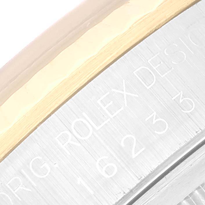 The image shows a close-up of the side case with engraved lettering of a Rolex Datejust 16233 Men's Steel and Gold (two tone) Grey Dial 16233 Men's Steel and Gold (two tone) Grey Dial watch.