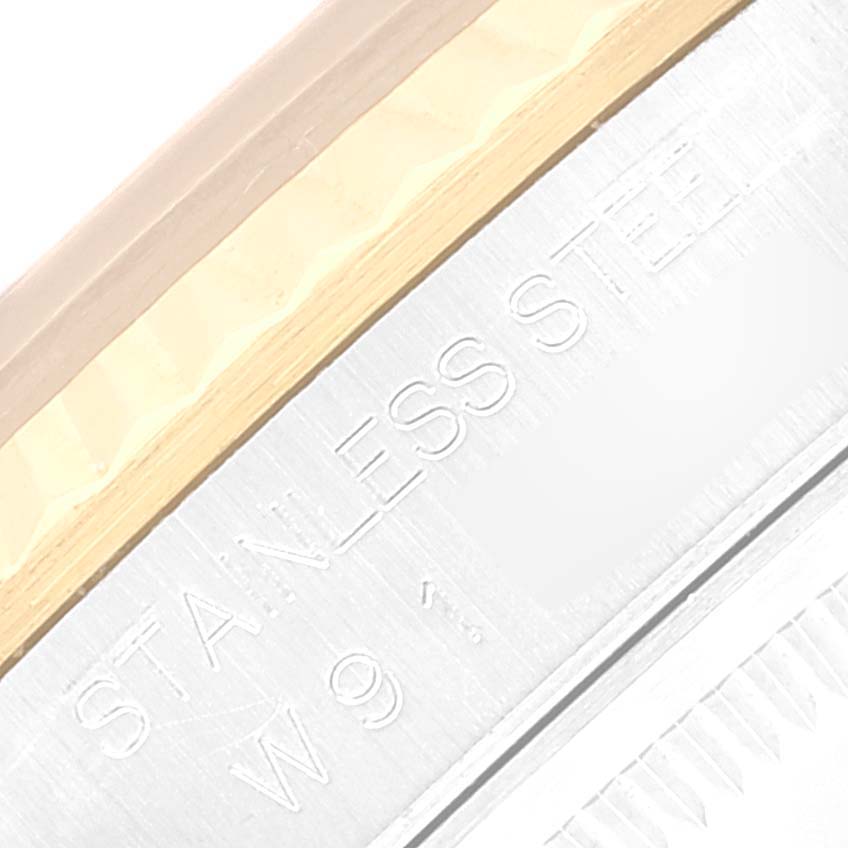 The image shows a close-up of the side engravings on a stainless steel bezel of a Rolex Datejust 16233 Men's Steel and Gold (two tone) Grey Dial 16233 Men's Steel and Gold (two tone) Grey Dial watch.