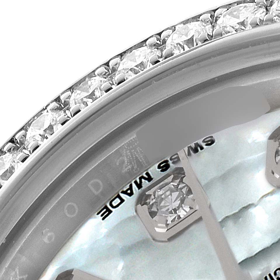 The image shows a close-up view of the bezel and part of the dial of a Rolex Datejust 179384 Women
s Stainless Steel Mother of Pearl Dial 179384 Women
s Stainless Steel Mother of Pearl Dial watch with diamond accents.