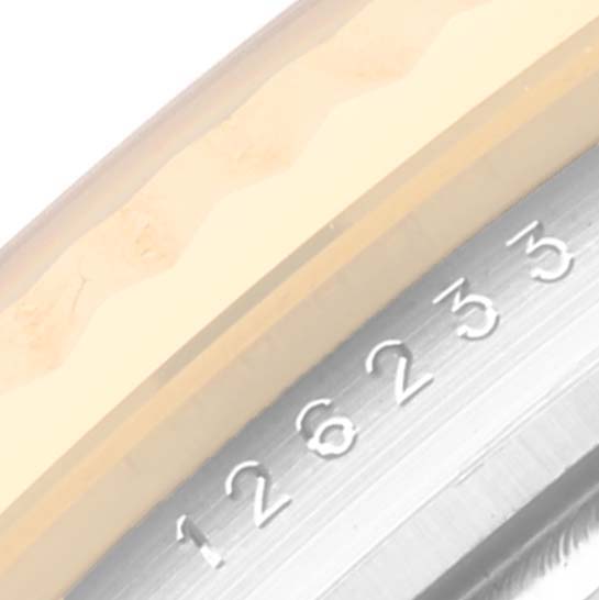 This image shows a close-up of the etched serial number on the side of the case of a Rolex Datejust 126233 Men's Steel and Gold (two tone) Black Dial 126233 Men's Steel and Gold (two tone) Black Dial watch.
