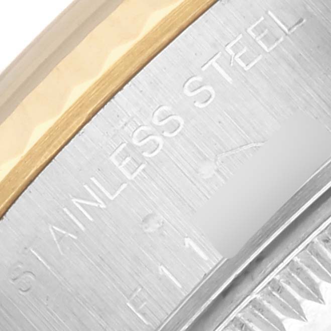 The image shows a close-up of the Rolex Datejust 79173 Women's Steel and Gold (two tone) Blue Dial 79173 Women's Steel and Gold (two tone) Blue Dial watch case's side, highlighting the "STAINLESS STEEL" engraving.