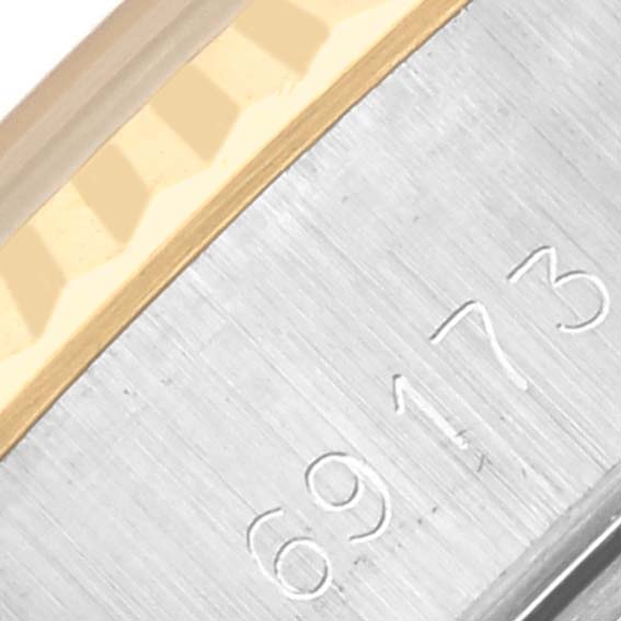 The image shows a close-up of the engraved model number and fluted bezel of a Rolex Datejust 69173 Women's Steel and Gold (two tone) Champagne Dial 69173 Women's Steel and Gold (two tone) Champagne Dial watch.