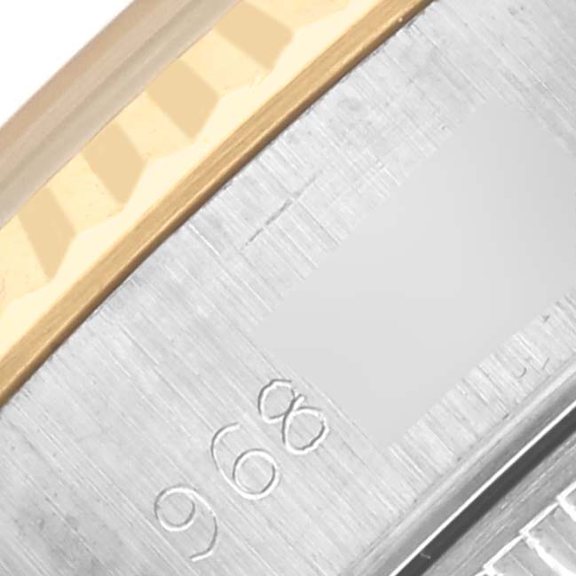 The image shows a close-up of the fluted bezel and edge of the casing of a Rolex Datejust 69173 Women's Steel and Gold (two tone) Champagne Dial 69173 Women's Steel and Gold (two tone) Champagne Dial watch, highlighting the serial engraving.