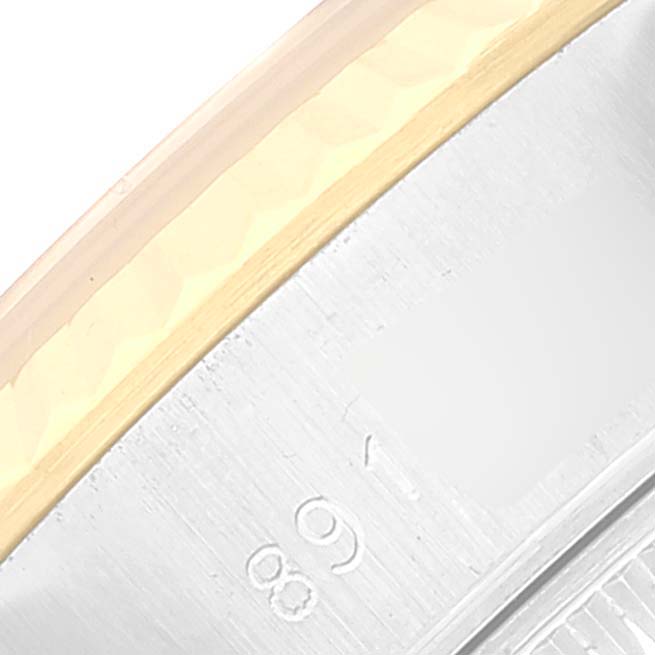 This close-up image shows the side of a Rolex Datejust 69173 Women's Steel and Gold (two tone) Champagne Dial 69173 Women's Steel and Gold (two tone) Champagne Dial watch, highlighting part of the bezel and case.