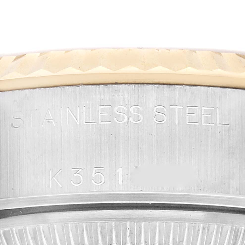 This image shows a close-up of the case back edge and fluted bezel of a Rolex Datejust 79173 Women's Steel and Gold (two tone) Champagne Dial 79173 Women's Steel and Gold (two tone) Champagne Dial watch made of stainless steel.