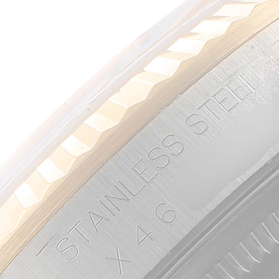 This is a close-up shot of the rim and engraved text on the back of a Rolex Date 16233 Men's Steel and Gold (two tone) Champagne Dial 16233 Men's Steel and Gold (two tone) Champagne Dial model watch.