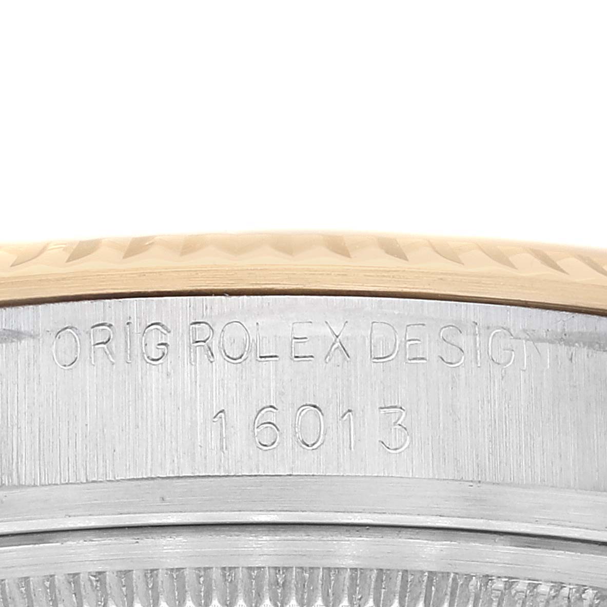 This image shows a close-up view of the Rolex Datejust 16013 Men's Steel and Gold (two tone) Champagne Dial 16013 Men's Steel and Gold (two tone) Champagne Dial model's case side and bezel with engraved model number 16013.
