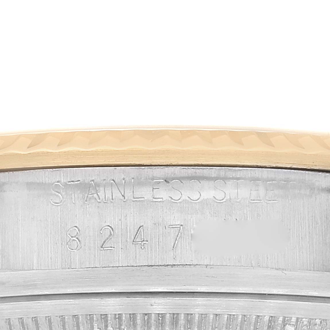 This image shows a close-up of the side of a Rolex Datejust 16013 Men's Steel and Gold (two tone) Champagne Dial 16013 Men's Steel and Gold (two tone) Champagne Dial, highlighting the stainless steel part and serial number.