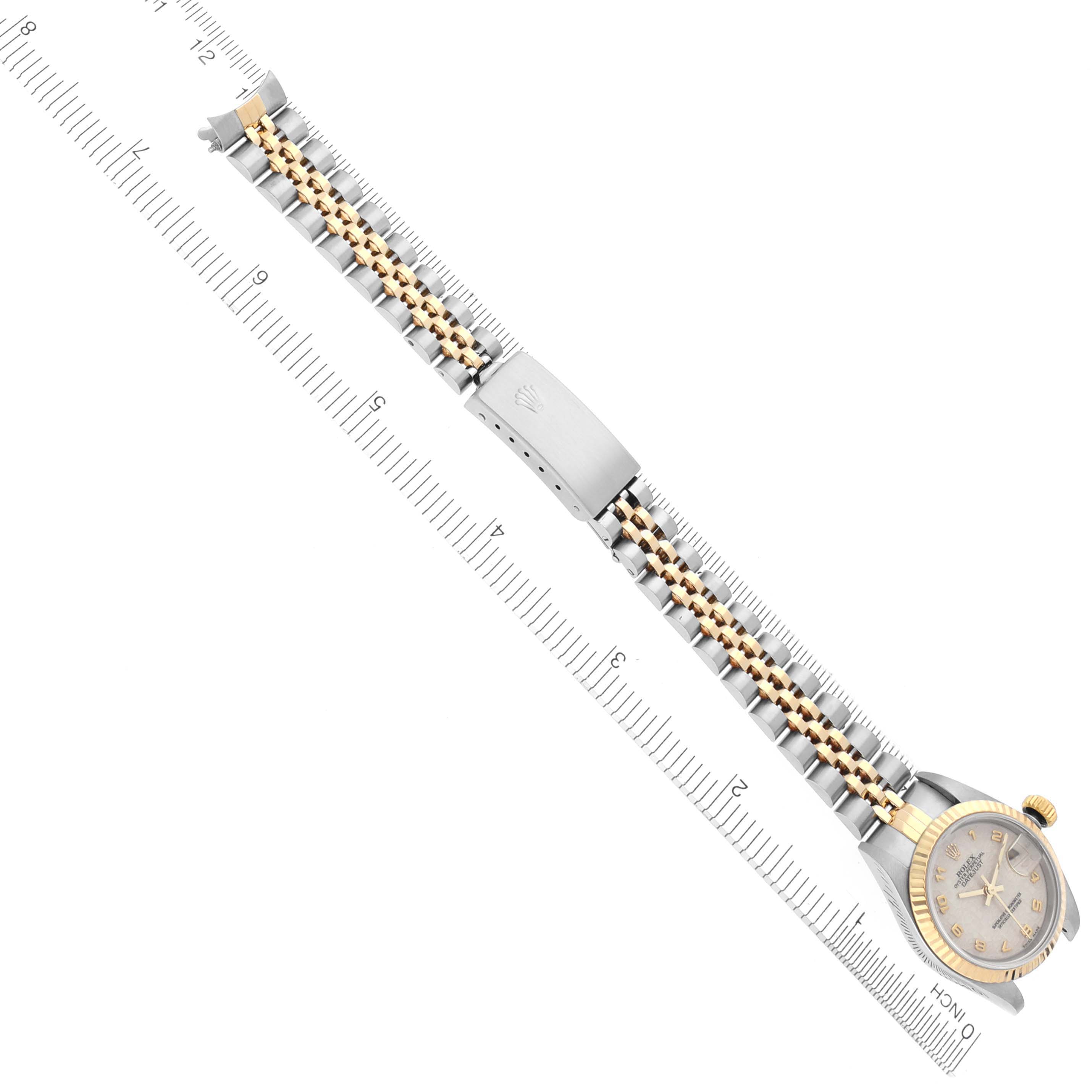 The Rolex Datejust 79173 Women's Steel and Gold (two tone) White Dial 79173 Women's Steel and Gold (two tone) White Dial watch is shown from a top-down angle, displaying the face, bezel, and two-tone bracelet with clasp.