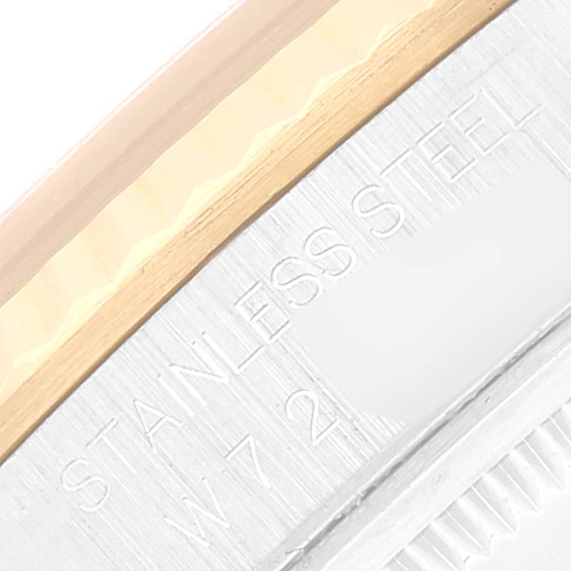 This image shows a close-up of the case and bezel of the Rolex Datejust 16233 Men's Steel and Gold (two tone) Champagne Dial 16233 Men's Steel and Gold (two tone) Champagne Dial watch, including the "STAINLESS STEEL" engraving.