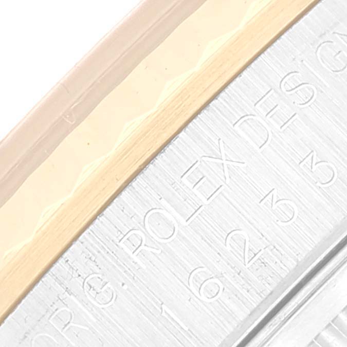 This image shows a close-up of the Datejust model by Rolex, focusing on part of the engraved bezel and metal bracelet.