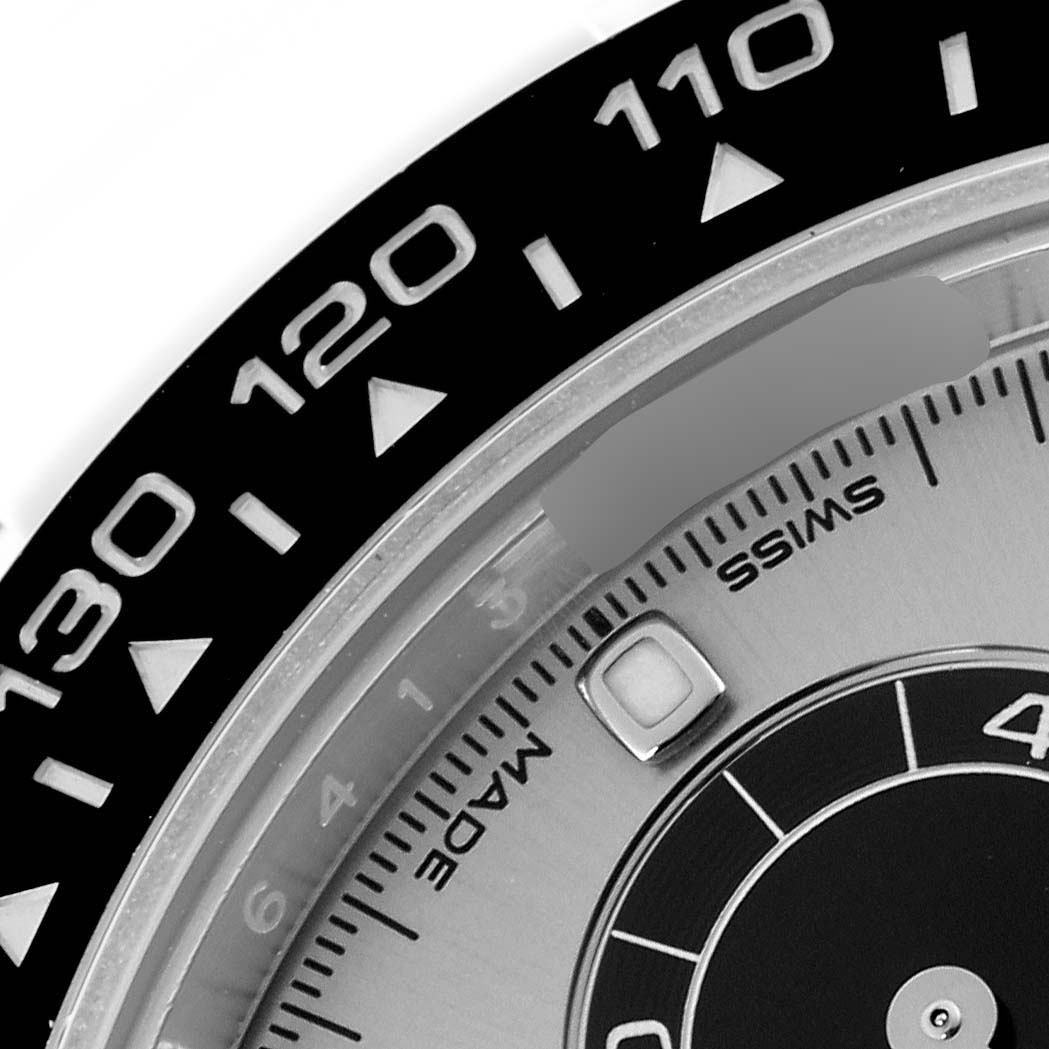 The image shows a close-up of the bezel and dial of a Rolex Daytona 116519LN Men's White Gold Silver Dial 116519LN Men's White Gold Silver Dial, focusing on the tachymeter and a sub-dial segment.