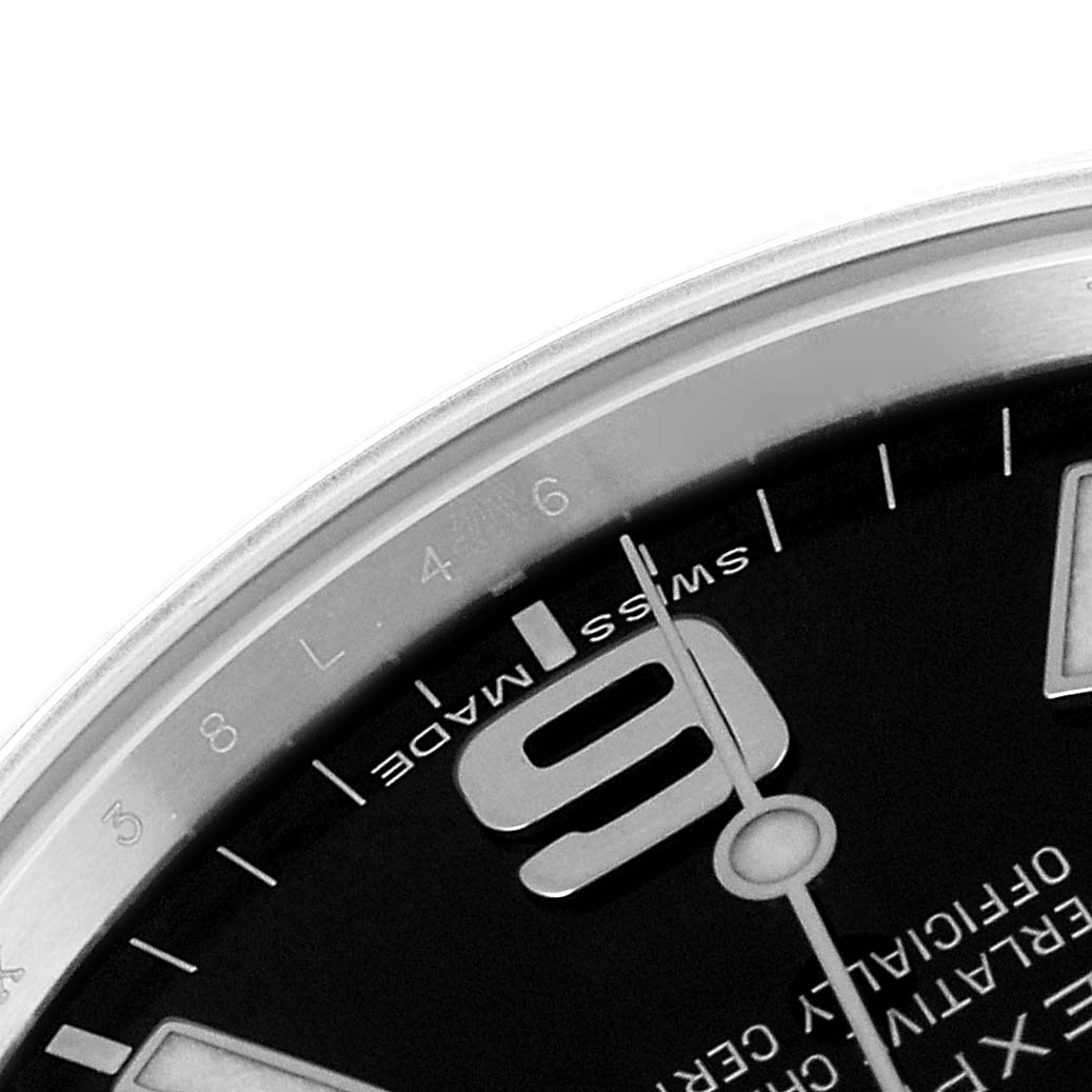 The image shows a close-up of the dial and bezel of a Rolex Explorer 214270 Men's Stainless Steel Black Dial 214270 Men's Stainless Steel Black Dial watch, focusing on the 9 o'clock marker and part of the chapter ring.