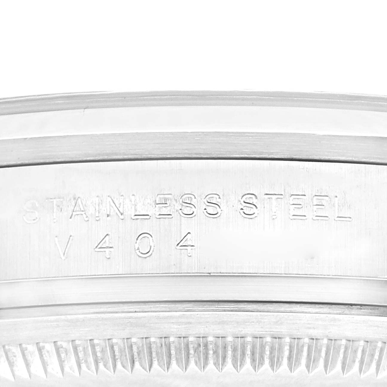 This is a close-up shot of the edge of the casing of a Rolex Explorer 114270 Men's Stainless Steel Black Dial 114270 Men's Stainless Steel Black Dial watch with "Stainless Steel V 404" engraved.