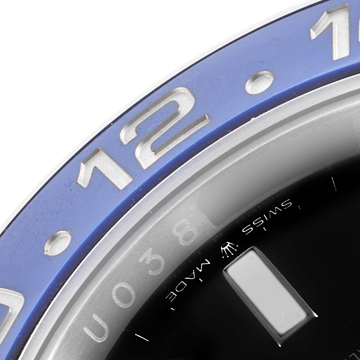 The image shows a close-up of Rolex GMT-Master 126710 Men
s Stainless Steel Black Dial 126710 Men
s Stainless Steel Black Dial model
s blue bezel and part of the black dial with a "Swiss Made" inscription.