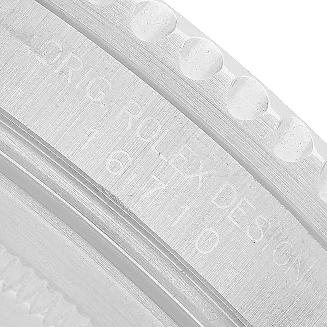 The image shows a close-up of the side engraving on a Rolex GMT-Master 16710 Men's Stainless Steel Black Dial watch bezel.