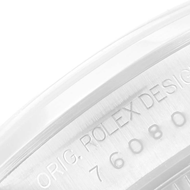 The image shows a close-up of the case side of the Rolex Datejust 76080 Women's Stainless Steel Black Dial 76080 Women's Stainless Steel Black Dial, revealing its model number and "Orig. Rolex Design" engraving.