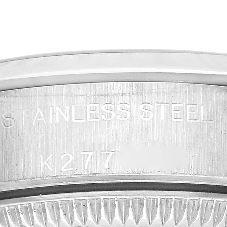 The image shows the engraved stainless steel case back of a Rolex Oyster Perpetual 76080 Women's Stainless Steel Blue Dial 76080 Women's Stainless Steel Blue Dial watch from a close-up angle.