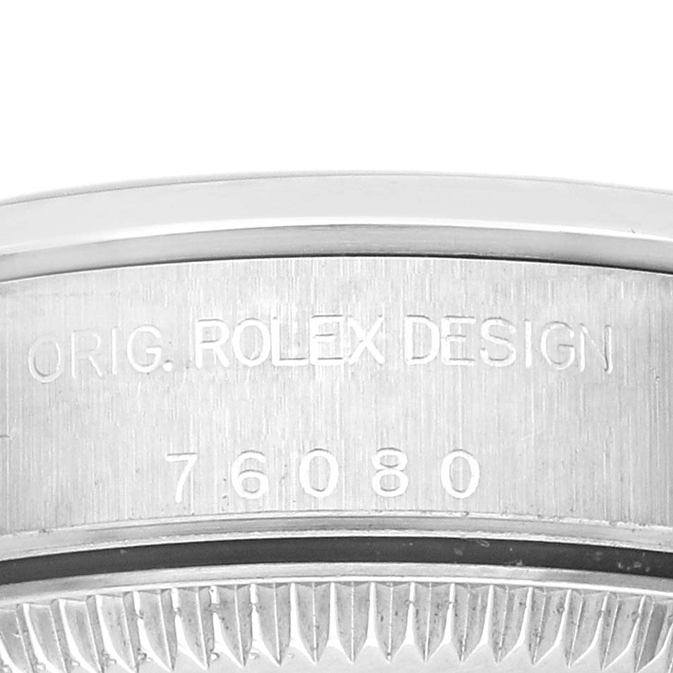 The image shows a close-up of the side engraving on the Rolex Oyster Perpetual 76080 Women's Stainless Steel Blue Dial 76080 Women's Stainless Steel Blue Dial watch case, featuring the model number.