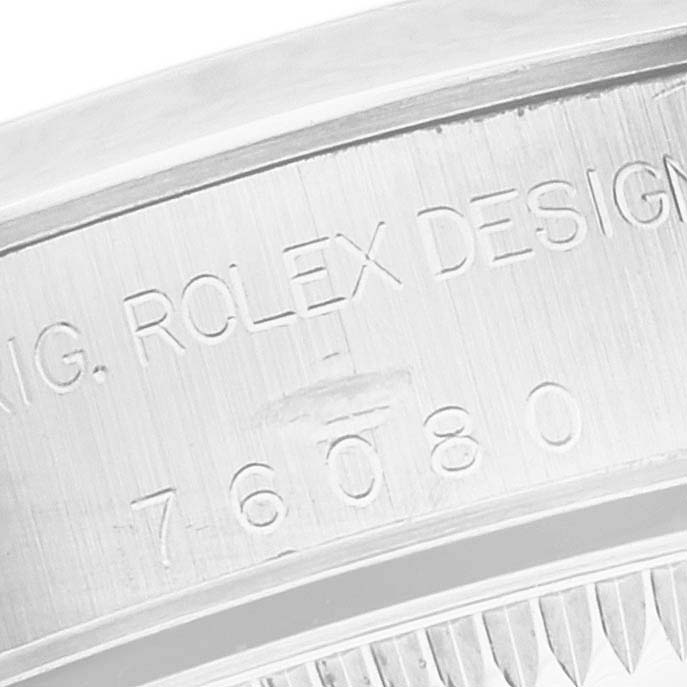 The image shows a close-up of the model number engraving on the case of an Oyster Perpetual watch by Rolex.